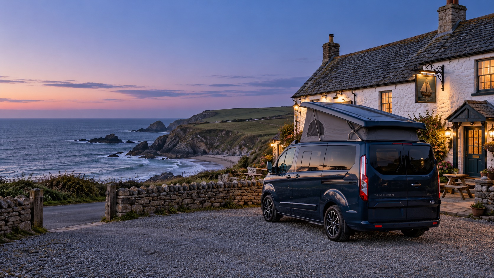 A campervan parked outside a coastal pub at dusk